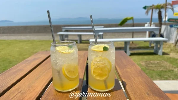 アロハテラスのスパークリングイエローレモネード（海を背景にした爽やかなドリンク）